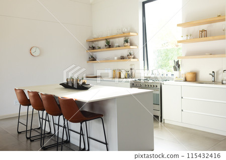 A modern kitchen features a central island with brown stools and white cabinetry, with copy space A modern kitchen features a central island with brown stools and white cabinetry, with copy space 115432416