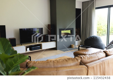 A modern living room features a large TV, a fireplace, and comfortable seating with copy space A modern living room features a large TV, a fireplace, and comfortable seating with copy space 115432438
