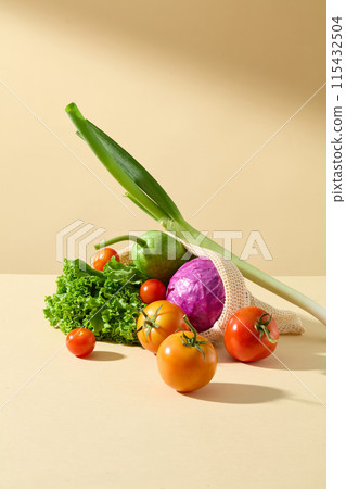 Vegetable theme photo in vertical frame, variety vegetables displayed on yellow countertop such as tomato, lettuce and green cabbage. Space for product presentation 115432504