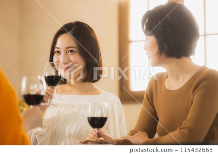 Women toasting with wine 115432663