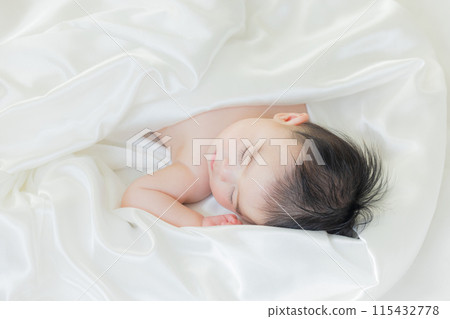 Baby sleeping wrapped in white cloth 115432778
