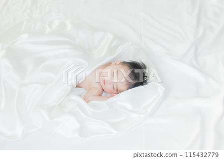Baby sleeping wrapped in white cloth 115432779