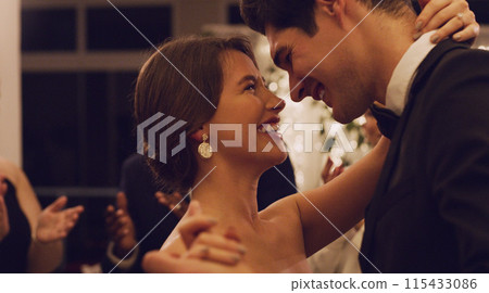 Wedding, man and woman with love, dance and happy for commitment, celebration and ceremony for couple. Venue, lovers and people with smile, night and bride with groom, marriage and event in hotel 115433086
