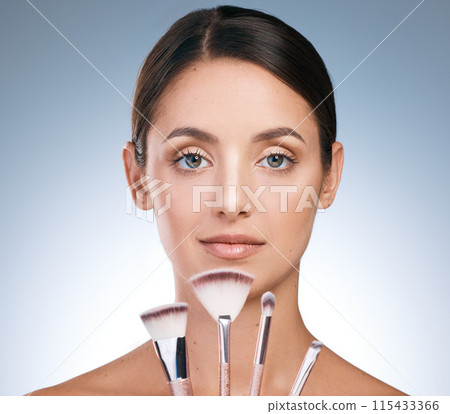 Cosmetic, woman and portrait with brushes for makeup, beauty and application on blue background. Tools, foundation and equipment for skincare products, female person face and studio for grooming 115433366