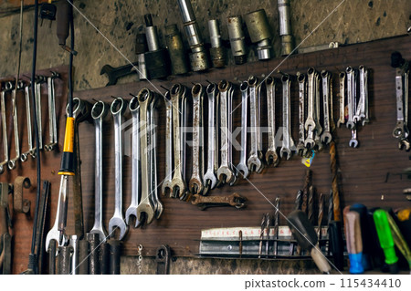 Various tools on the wall hand tools, ratchets, wrenches, cutting tools Various tools on the wall hand tools, ratchets, wrenches, cutting tools 115434410