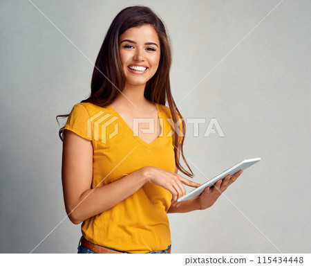 Woman, happy and portrait with tablet in studio background for social media, networking and communication. Female person, smile and satisfied with good news, streaming platform and entertainment Woman, happy and portrait with tablet in studio background for social media, networking and communication. Female person, smile and satisfied with good news, streaming platform and entertainment 115434448