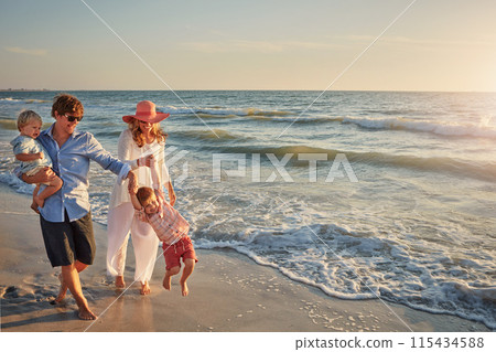 Family, parents and playing with kids on beach for bonding, outdoor holiday or weekend in nature. Mom, father or children enjoying water for embrace, love or care in sunshine by ocean coast or sea 115434588