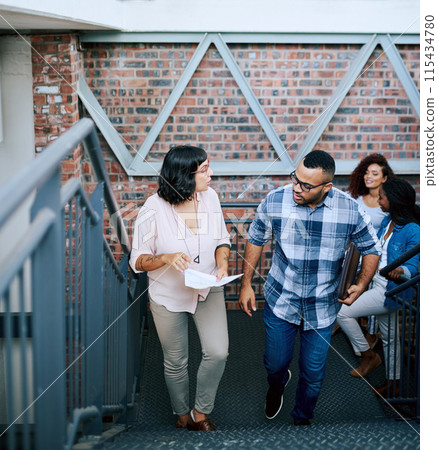 Walking, talking and business people with design ideas, project proposal and laptop in office. Creativity, man and woman at digital agency with paperwork, conversation and brainstorming on stairs. 115434780
