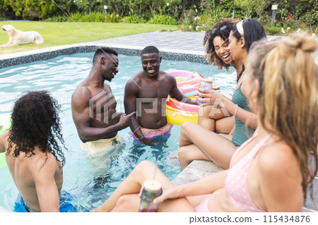 Diverse group of friends enjoy a pool party, laughing together Diverse group of friends enjoy a pool party, laughing together 115434876