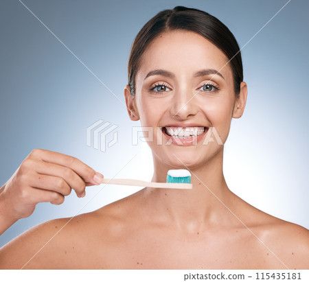 Dental care, portrait and happy woman with toothbrush in studio for hygiene, cleaning or wellness on blue background. Girl, bamboo brush and smile in morning for organic product, routine or freshness 115435181