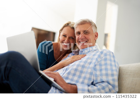 Couple, couch and laptop with portrait in home, streaming and relax in living room for movies. Internet, computer or website for video and mature married people, smile and lounge with technology Couple, couch and laptop with portrait in home, streaming and relax in living room for movies. Internet, computer or website for video and mature married people, smile and lounge with technology 115435322