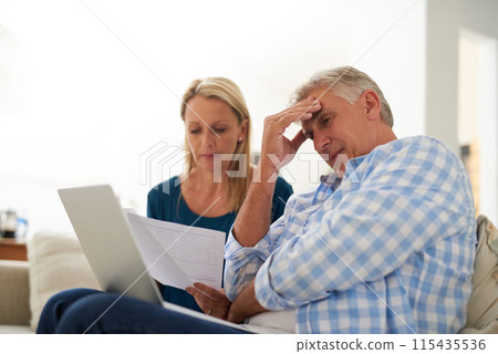 Couple, couch and document with laptop and stress, finances or taxes for debt in living room. Paperwork, planning or online for mortgage, upset people and budget for inflation or bankruptcy in home Couple, couch and document with laptop and stress, finances or taxes for debt in living room. Paperwork, planning or online for mortgage, upset people and budget for inflation or bankruptcy in home 115435536