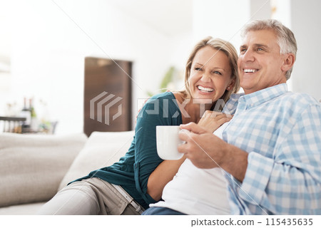 Relax, coffee and mature couple on sofa for love, connection or bonding together in living room. Romance, smile and married people for healthy relationship, conversation or weekend break in home Relax, coffee and mature couple on sofa for love, connection or bonding together in living room. Romance, smile and married people for healthy relationship, conversation or weekend break in home 115435635