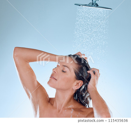 Woman, shower and shampoo in studio for washing hair, water and cleaning on blue background. Female person, cosmetic and foam for treatment in routine, haircare grooming and hygiene or conditioner Woman, shower and shampoo in studio for washing hair, water and cleaning on blue background. Female person, cosmetic and foam for treatment in routine, haircare grooming and hygiene or conditioner 115435636