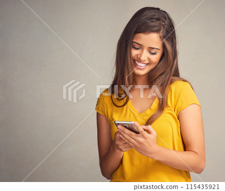 Woman, smile and notification with smartphone in studio background for social media, networking and online dating. Female person, happy and satisfied with good news, text message and mockup space Woman, smile and notification with smartphone in studio background for social media, networking and online dating. Female person, happy and satisfied with good news, text message and mockup space 115435921