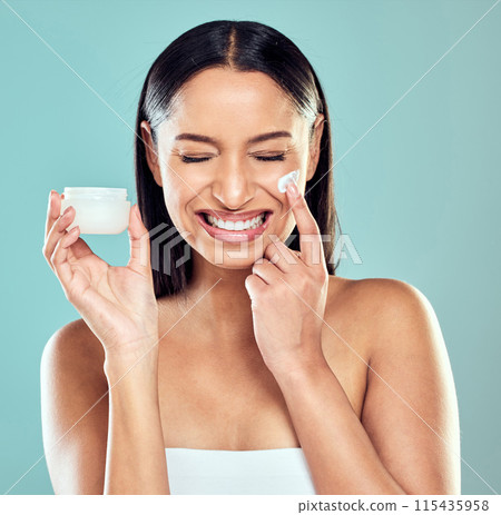 Smile, jar and woman with face cream for glow, skin transformation and anti aging results in studio. Model girl, dermatology and facial lotion with collagen for skincare and beauty by blue background 115435958