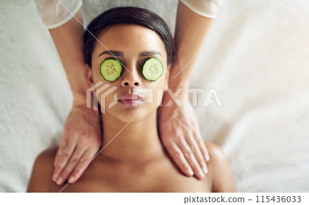 Woman, massage and cucumber for relax and treatment, hands and salon or spa for selfcare. Pamper, grooming or eye mask for hydration and organic, stress relief or skincare or wellness for calm person 115436033