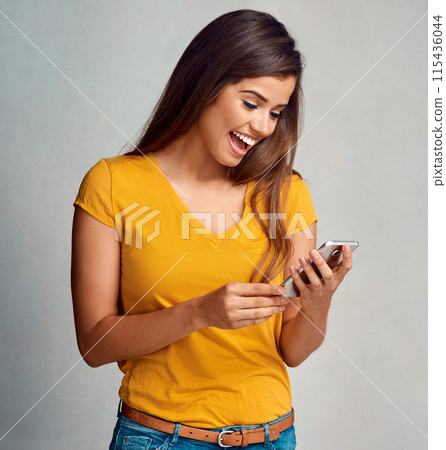 Woman, smile and notification with smartphone in studio background for social media, networking and online dating. Female person, happy and satisfied with good news, text message and entertainment 115436044