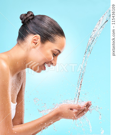 Woman, water on hands and happy for beauty, skincare and hygiene for wellness and shower routine. Closeup, stream splash and washing for health hydration, cleaning and smile by studio blue background 115436109