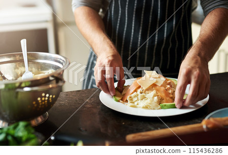Person, plate and cooking food in home for dinner or eating on kitchen counter with pasta and cheese. Male chef, dish and meal prep for lunch, wellness and brunch with salad for dining in house Person, plate and cooking food in home for dinner or eating on kitchen counter with pasta and cheese. Male chef, dish and meal prep for lunch, wellness and brunch with salad for dining in house 115436286