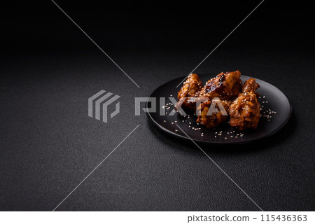 Delicious crispy grilled wings with teriyaki sauce with salt, spices 115436363