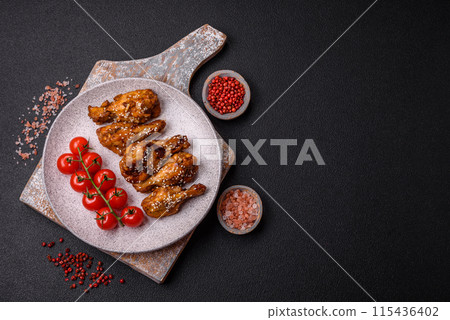 Delicious crispy grilled wings with teriyaki sauce with salt, spices Delicious crispy grilled wings with teriyaki sauce with salt, spices 115436402