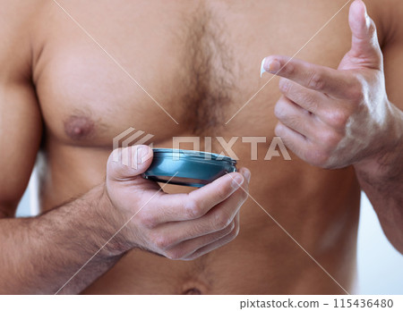Hands, skincare and man with luxury cream on studio background for moisturizer, cosmetics or morning routine. Closeup, grooming and chest of model with product for lotion, sunscreen or body care 115436480
