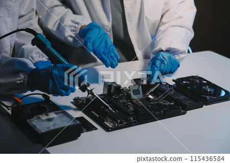 Close up of Technician measuring voltage electronic circuit board television, Service after sale fix electric equipment within insurance. 115436584