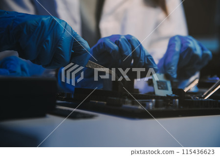 Close up of Technician measuring voltage electronic circuit board television, Service after sale fix electric equipment within insurance. Close up of Technician measuring voltage electronic circuit board television, Service after sale fix electric equipment within insurance. 115436623