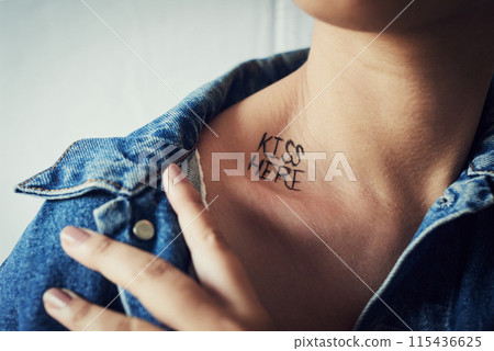 Woman, black ink or neck tattoo for aesthetic or wellness, smooth and soft with sexy gesture. Female person, showing and cosmetic with skincare for body art, collarbone and kiss here in design 115436625