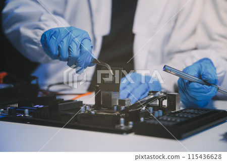 Close up of Technician measuring voltage electronic circuit board television, Service after sale fix electric equipment within insurance. 115436628