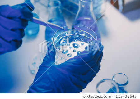chemist,scientist hand dropping chemical liquid into test tube, science research and development concept 115436645