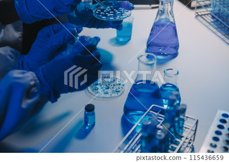 chemist,scientist hand dropping chemical liquid into test tube, science research and development concept 115436659