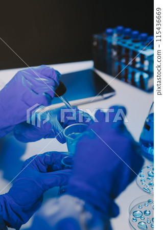 chemist,scientist hand dropping chemical liquid into test tube, science research and development concept chemist,scientist hand dropping chemical liquid into test tube, science research and development concept 115436669