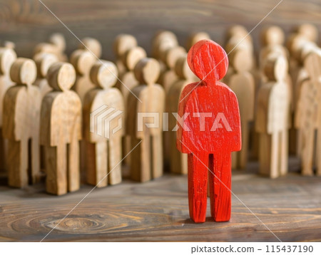 Red wooden figure stands out among crowd of wooden figures, symbolizing individuality, leadership 115437190