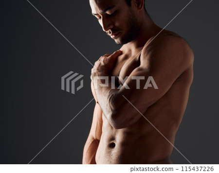 Man, shoulder and fitness in studio with thinking, abs and muscles on black background. Active person, bodybuilder or topless for workout with flex, athlete and healthy body or pride with progress Man, shoulder and fitness in studio with thinking, abs and muscles on black background. Active person, bodybuilder or topless for workout with flex, athlete and healthy body or pride with progress 115437226
