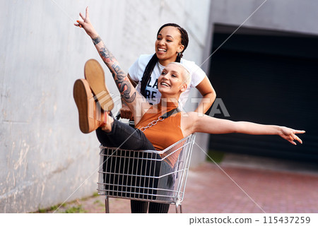 Friends, happy and shopping cart in outdoor for play, funny and bonding together in city for freedom. Women, town and adventure in trolley for comedy, laughing and crazy happiness in urban on weekend Friends, happy and shopping cart in outdoor for play, funny and bonding together in city for freedom. Women, town and adventure in trolley for comedy, laughing and crazy happiness in urban on weekend 115437259