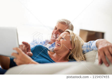 Relax, couple and happy with tablet on sofa for funny, online film and subscription on website. Mature man, woman and laughing with technology in house for entertainment, streaming and comedy movie Relax, couple and happy with tablet on sofa for funny, online film and subscription on website. Mature man, woman and laughing with technology in house for entertainment, streaming and comedy movie 115437455