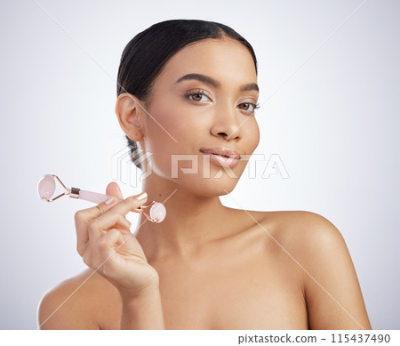 Skincare, portrait or derma roller by Mexican girl in studio for facelift, cosmetics and anti aging on white background. Rose quartz, crystal or model with stone facial, lymphatic drainage or massage 115437490