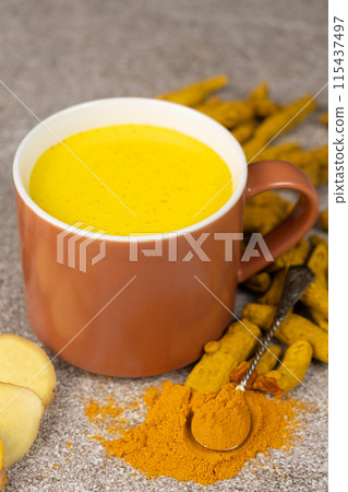Natural Ayurvedic drink golden milk with turmeric and spices in a mug Natural Ayurvedic drink golden milk with turmeric and spices in a mug 115437497