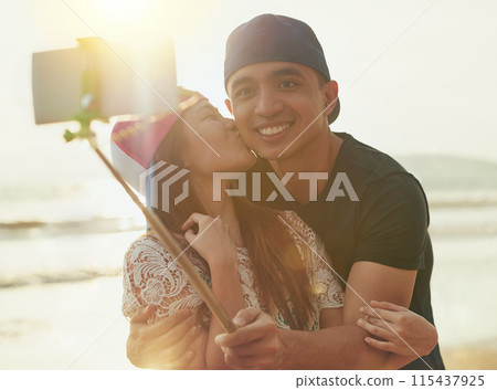 Selfie, couple and kiss on beach for love, support and together in nature with sunshine. Technology, man and woman outdoor for travel, adventure and holiday to Thailand for happiness in summer 115437925
