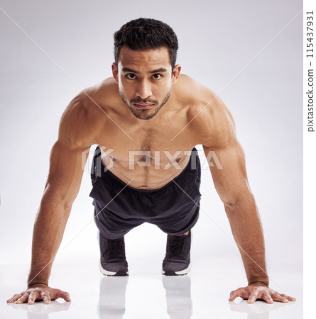 Portrait, push up and man in studio for fitness, body care and wellness for health and muscles. Male person, athlete or bodybuilder and training for strength, exercise and workout by white background 115437931
