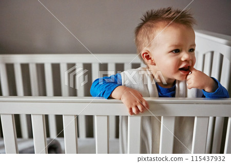 Cute, thinking and playful baby in crib on a blanket for child development, health and childhood. Happy, sweet and kid for cheerful infant boy relaxing on a bed in his home nursery or bedroom cradle Cute, thinking and playful baby in crib on a blanket for child development, health and childhood. Happy, sweet and kid for cheerful infant boy relaxing on a bed in his home nursery or bedroom cradle 115437932