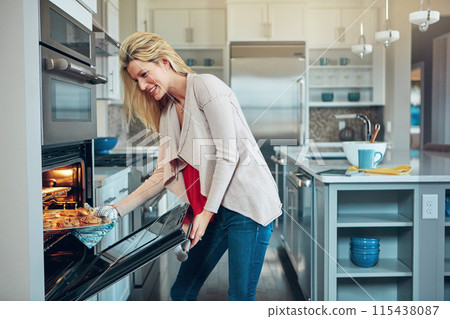 House, baking and woman with cookie pan, tray and preparation in stove oven. Kitchen, electronic equipment and female baker with smile for cooking, pastry and chocolate biscuits in modern home 115438087