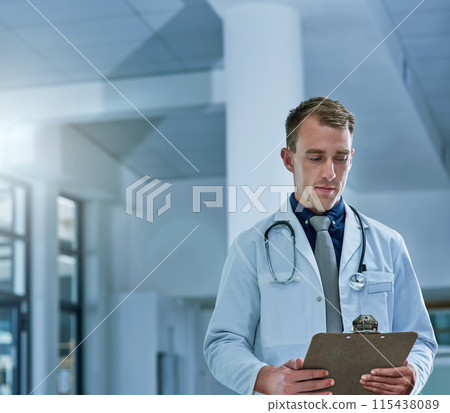 Man, doctor and planning or reading on clipboard in hospital for healthcare paperwork, strategy or notes. Male medical expert with documents, prescription or medicare details at clinic for report 115438089