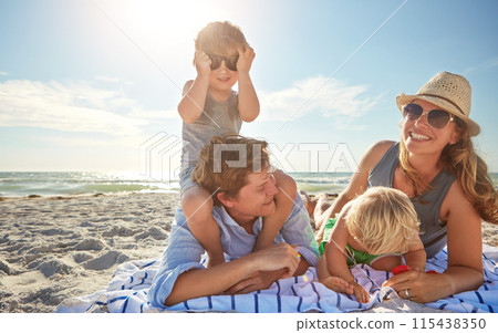Portrait, piggyback or children with family at sea for vacation, holiday or summer together with parents. Father, mother or happy kids siblings at beach for bonding, love or playing by ocean to relax 115438350