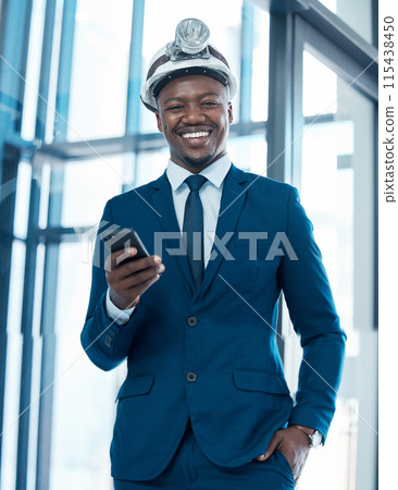 Portrait, businessman on cellphone and construction hat for project, development and networking in office. Technology, planning and happy architect in workplace with internet for online communication Portrait, businessman on cellphone and construction hat for project, development and networking in office. Technology, planning and happy architect in workplace with internet for online communication 115438450