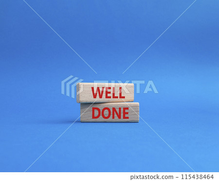 Well done symbol. Wooden blocks with words Well done. Beautiful blue background. Business and Well done concept. Copy space. Well done symbol. Wooden blocks with words Well done. Beautiful blue background. Business and Well done concept. Copy space. 115438464