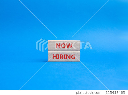 Now Hiring symbol. Concept word Now Hiring on wooden blocks. Beautiful blue background. Business and Now Hiring concept. Copy space Now Hiring symbol. Concept word Now Hiring on wooden blocks. Beautiful blue background. Business and Now Hiring concept. Copy space 115438465