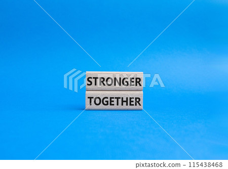 Stronger together symbol. Wooden blocks with words Stronger together. Beautiful blue background. Stronger together concept. Copy space. 115438468